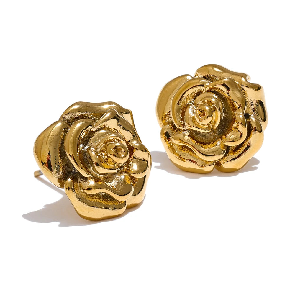 Gold rose-shaped earrings on a white background