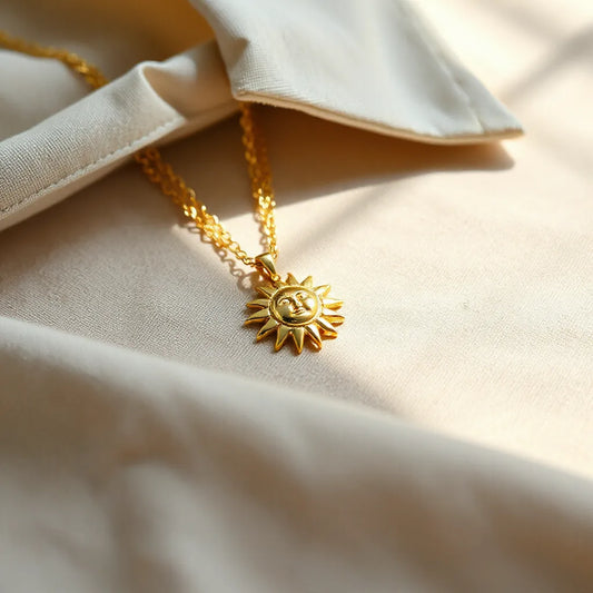 Gold sun pendant necklace with a polished circular pendant and delicate chain on neutral fabric