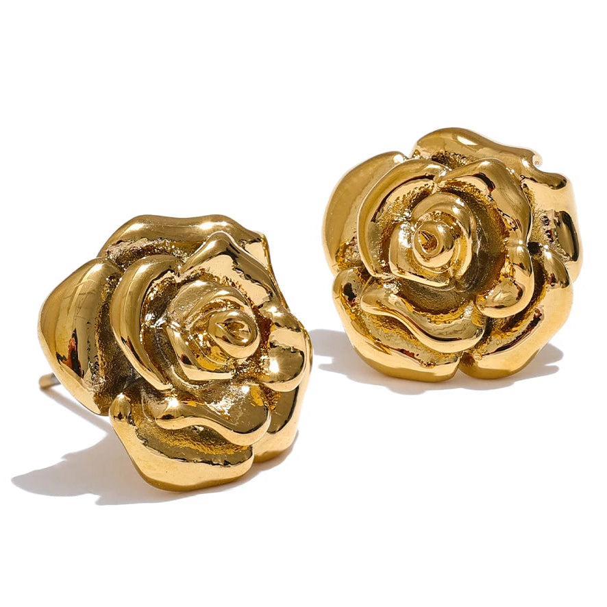 Gold rose-shaped earrings on a white background