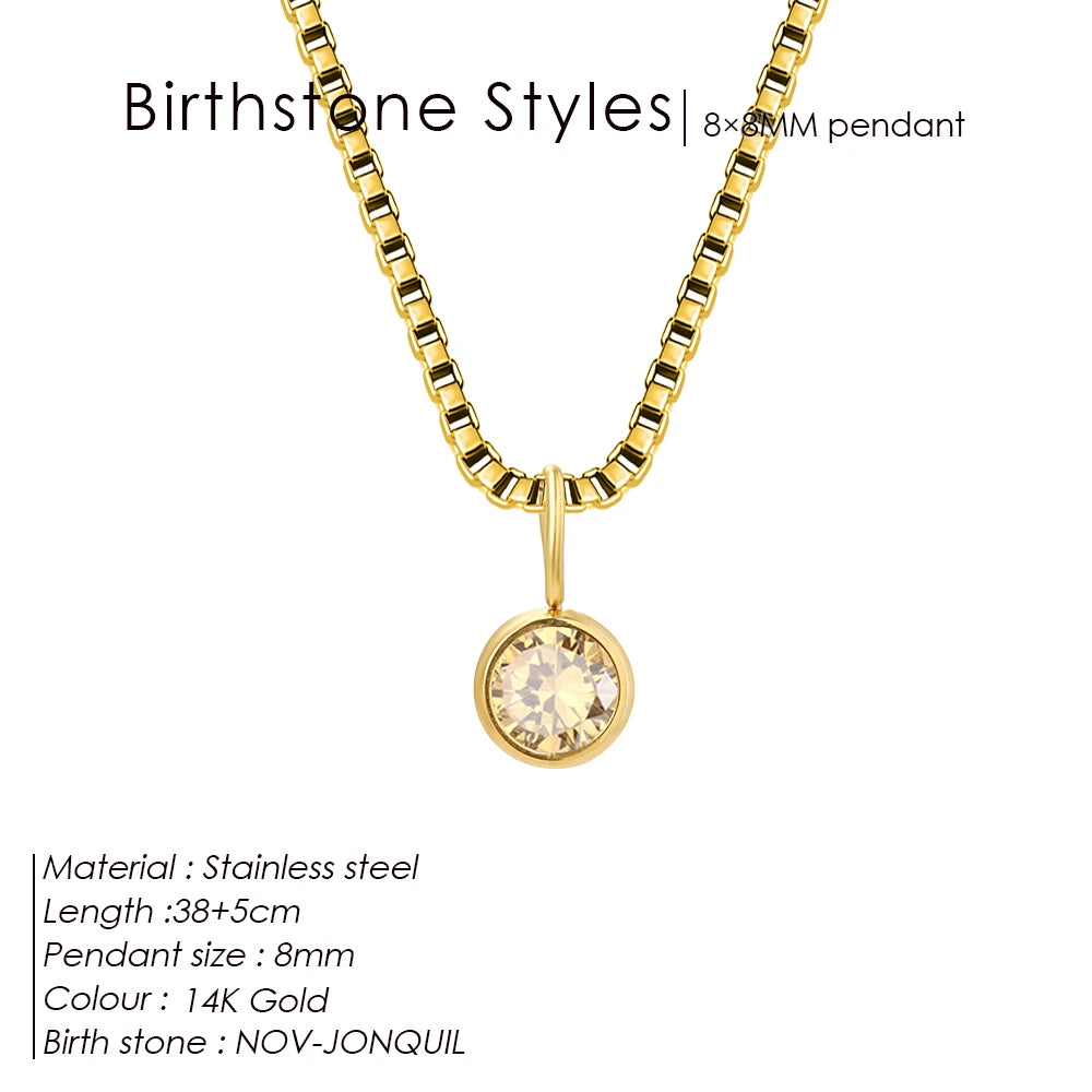 Gold necklace with a round pendant on a white background