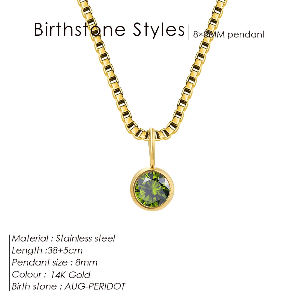 Gold necklace with a green gemstone pendant on a white background