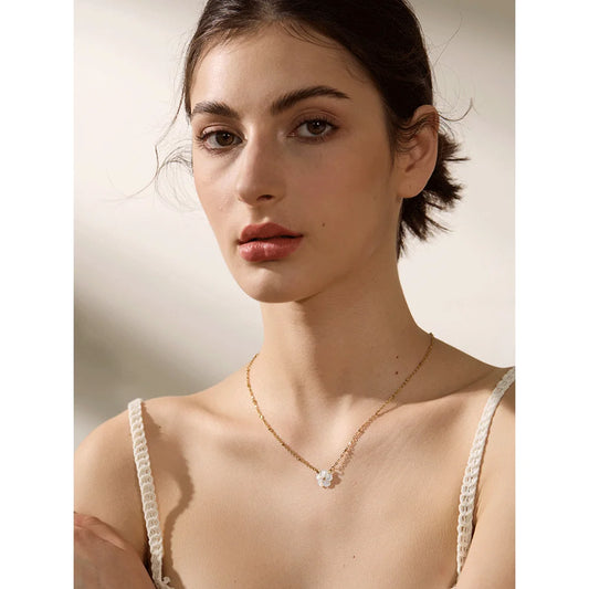 Woman wearing a delicate necklace with a blurred background