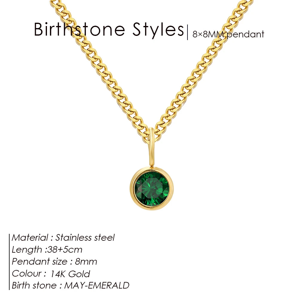 Gold necklace with a green gemstone pendant on a white background