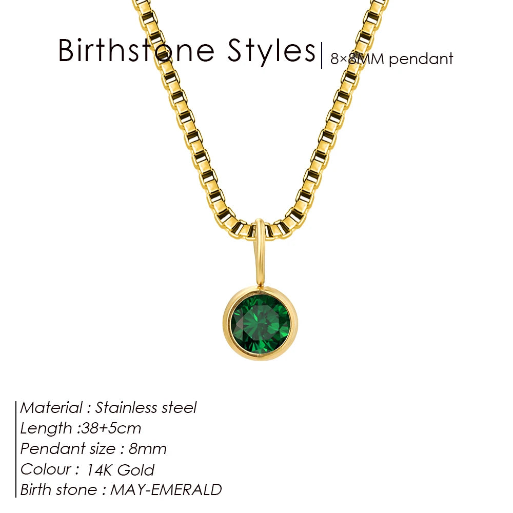 Gold necklace with a green gemstone pendant on a white background