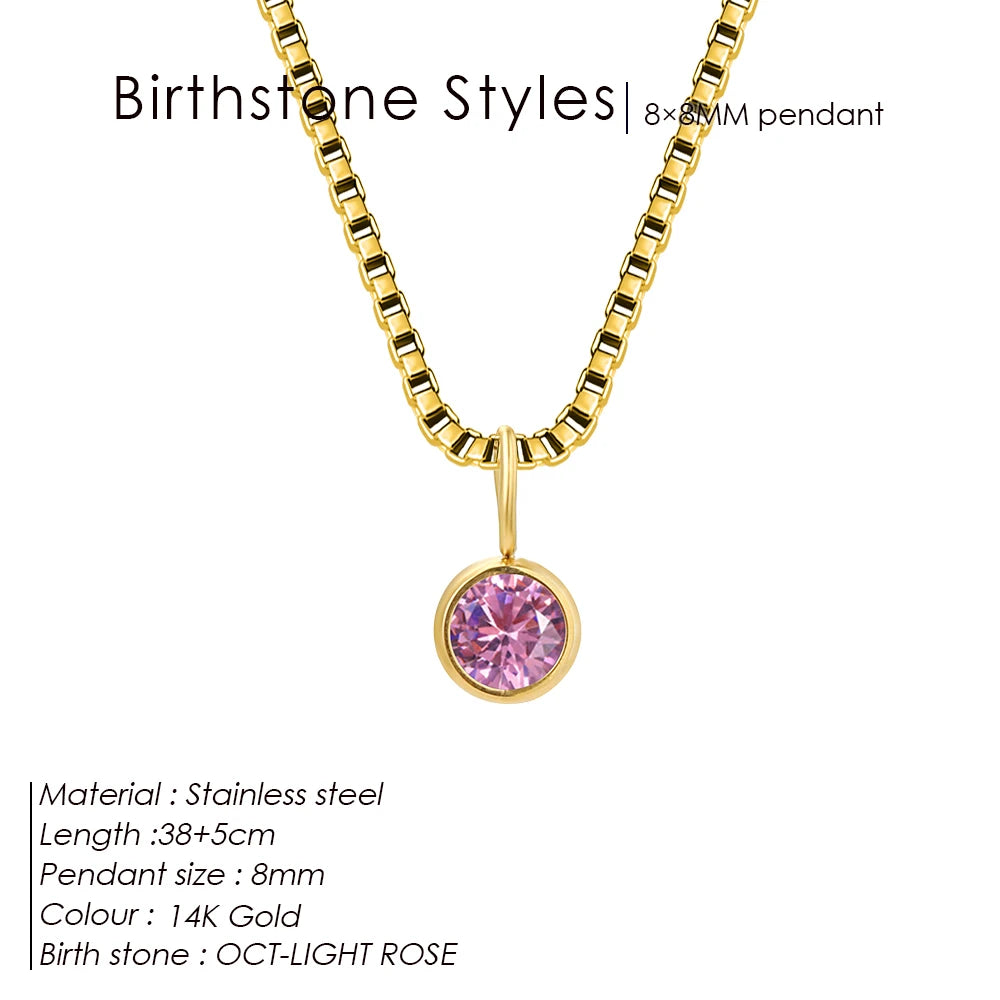 Gold necklace with a pink birthstone pendant on a white background